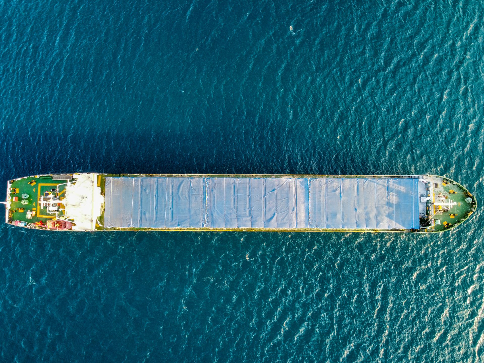 Aerial view of a cargo vessel navigating open ocean